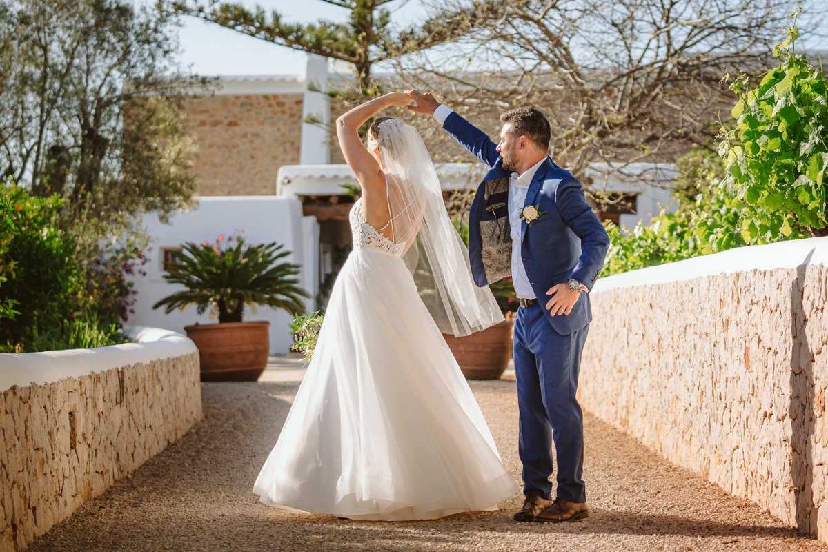 Can Gall Ibiza wedding photographer captures wedding couple twirling on the terrace
