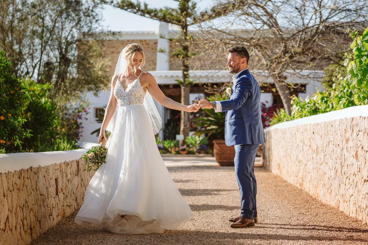 Can Gall Ibiza wedding photographer takes photo of bride and groom dancing on the pathway